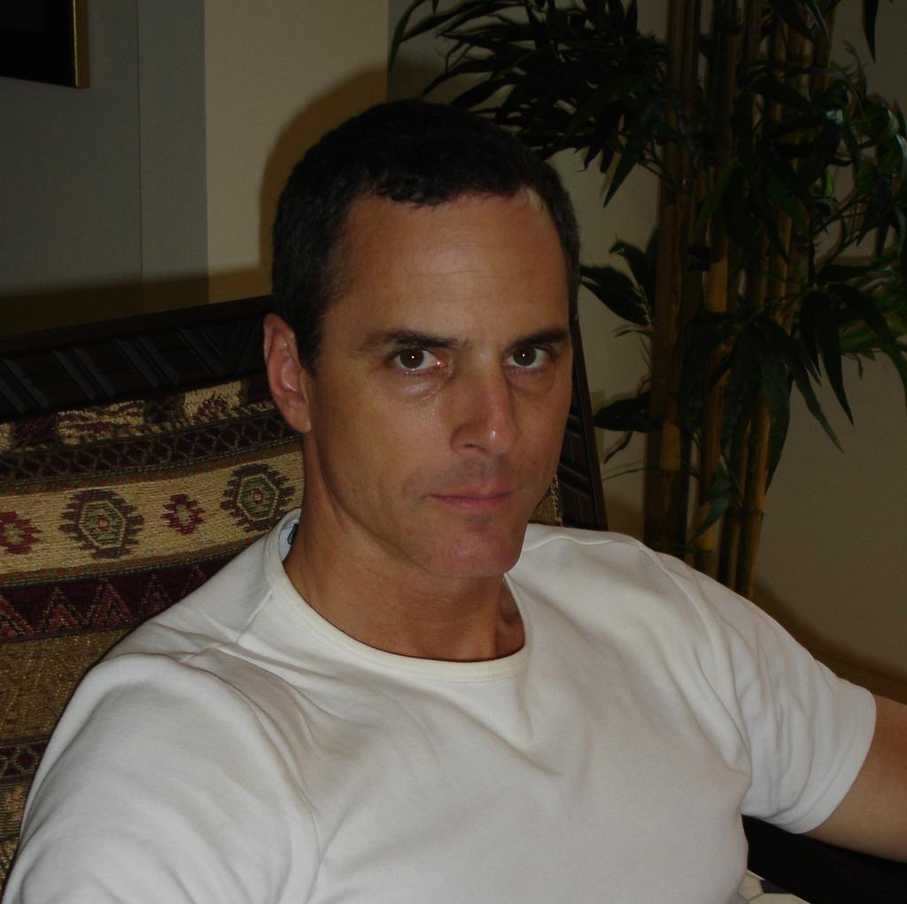 John Hughes carrying side arm and M16