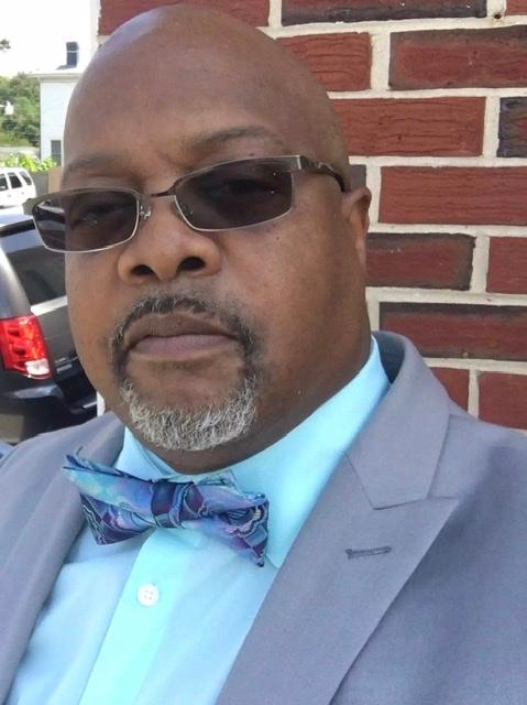 John Hughes standing in front of our utility truck I Crop Headquaters